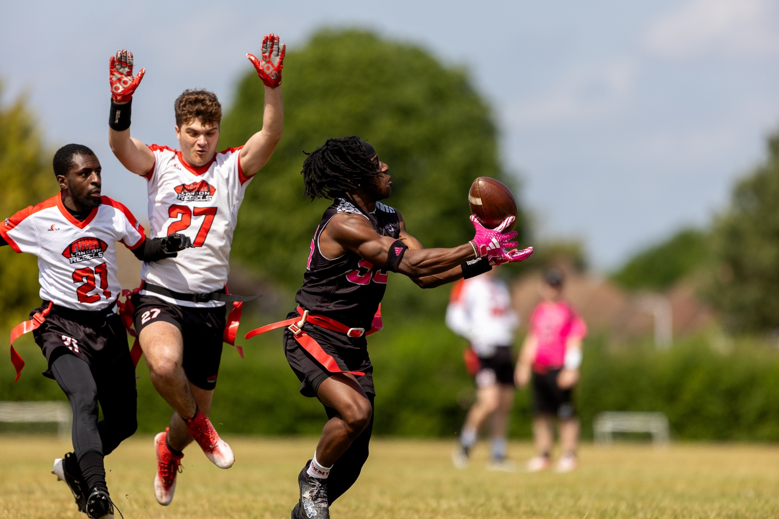 A flag american football player catching a deep ball